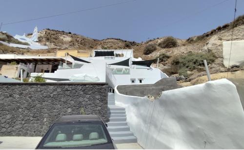 a car is parked on the stairs of a house at The Magic Luxury Cave Suites in Vóthon