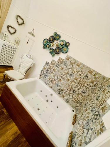 a bath tub sitting on a wall with a table at LOVE guest house in Modugno