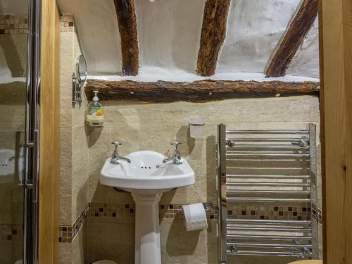 a bathroom with a sink and a shower at Hay Meadow Farm, Cosy Thatched Holiday Cottage in Beaworthy