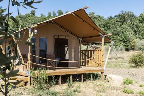 a small house with a porch in a field at Tenuta San Lodovico in Scansano