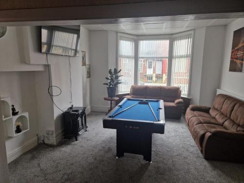 a living room with a pool table in it at Lynalan Hotel in Blackpool