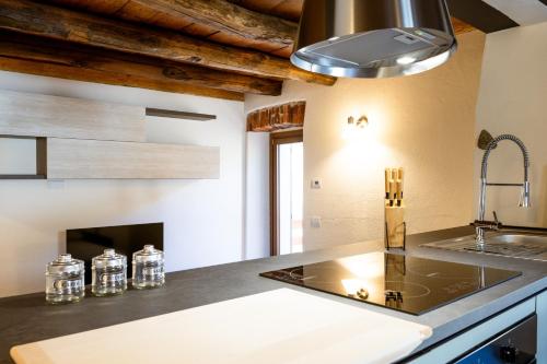 a kitchen with a sink and a stove at Casa Sina -la villetta nel borgo in Massino Visconti