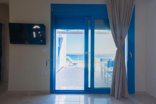 an open glass door with a view of a patio at VILLES RANIA in Karpathos Town
