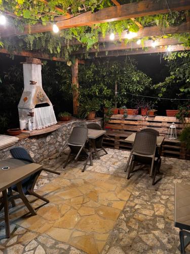 a patio with tables and chairs and a fireplace at Le Tre Rose in Maratea