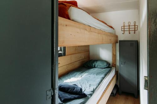 a bedroom with two bunk beds in a room at Tiny Cabin Mae op de Veluwe in Putten