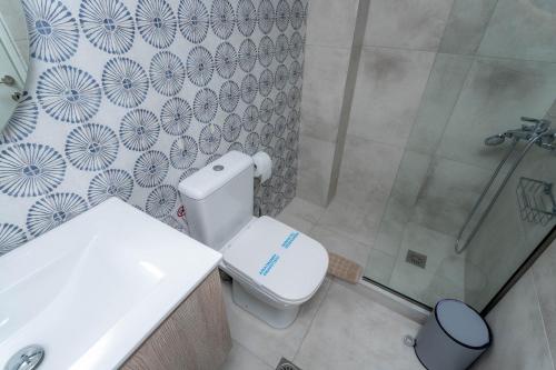 a bathroom with a toilet and a shower at Pteleo Apartments in Pteleós