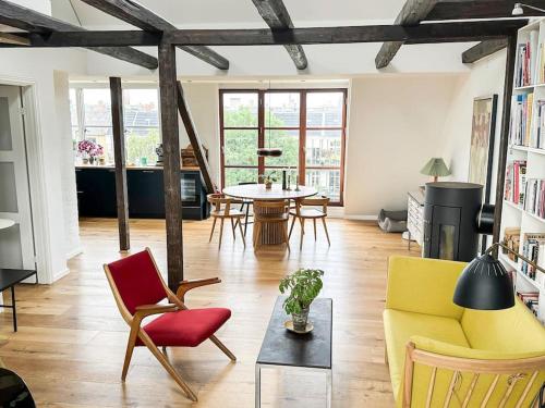 a living room with a couch and chairs and a table at Penthouse med egen tagterrasse in Copenhagen