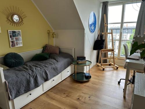 a bedroom with a bed and a table in it at Penthouse med egen tagterrasse in Copenhagen