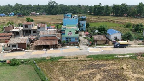 an aerial view of a small village with a house at Hong Qi Hotel in Chitwan