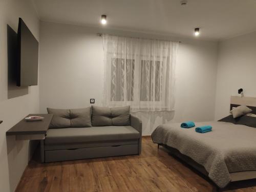 a living room with a couch and a bed at fonyodapartman in Fonyód