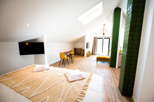 a bedroom with a bed and a living room at Mira D'Ouro Sertã in Sertã