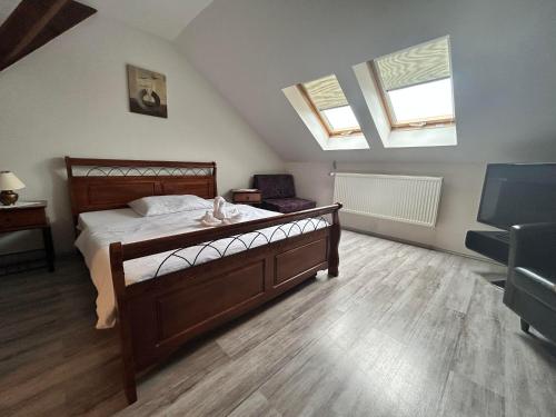 a bedroom with a bed and two windows at Penzión CONTESA in Rožňava