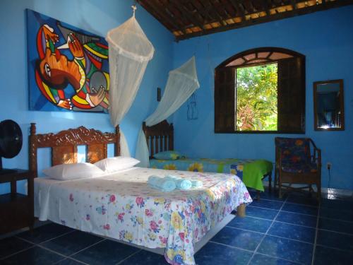 A bed or beds in a room at Pousada Villa Amari