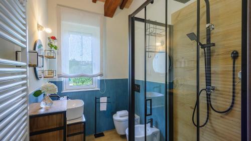 a bathroom with a shower and a toilet and a sink at VILLINO LE MOIE 4&2, Emma Villas in Fermo