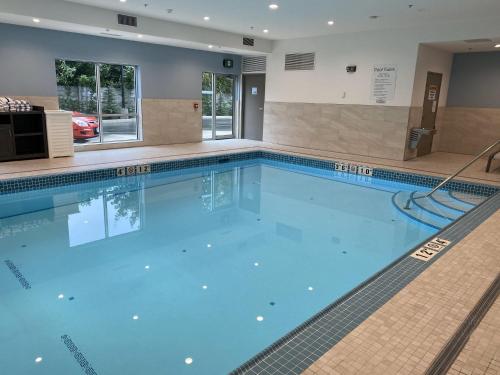 a large swimming pool with blue water at Holiday Inn Express & Suites - Courtenay - Comox by IHG in Courtenay