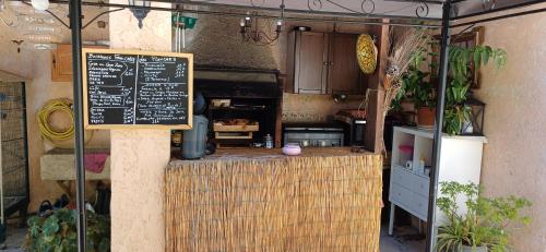 a kitchen with a counter with a chalkboard on it at le Mas d'Hubert in LʼIsle-sur-la-Sorgue