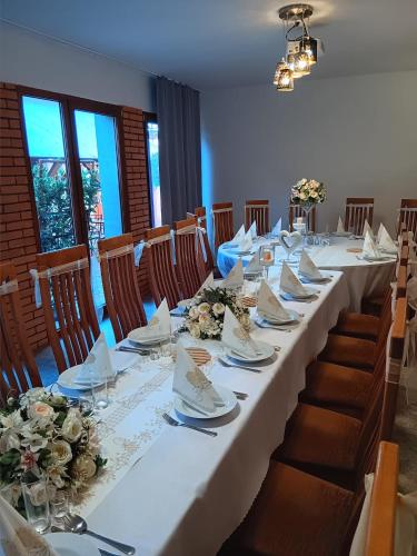 a long table with plates and napkins on it at Penzión CONTESA in Rožňava