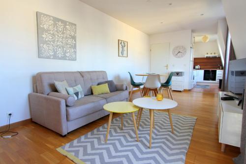 un salon avec un canapé et deux tables dans l'établissement ELBE3 Apartment up to 4ppl - Disneyland, à Serris