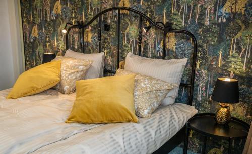 a bedroom with a bed with yellow pillows at Diamond dream in Ptuj