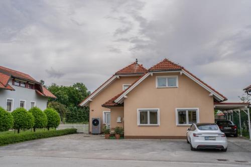 a house with a car parked in a driveway at Diamond dream in Ptuj