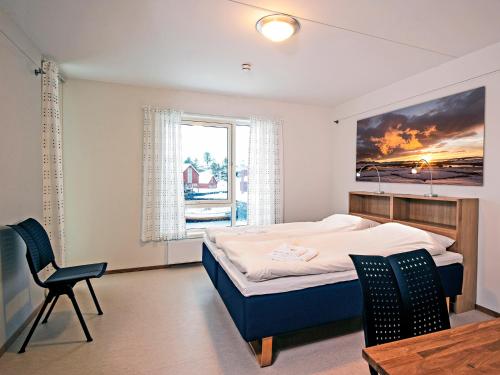 A bed or beds in a room at Lofoten sommerhotell og vandrerhjem