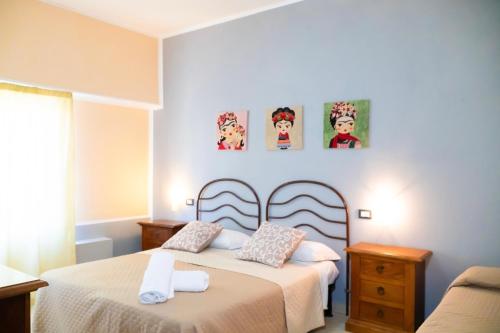 a bedroom with two beds and a couch at Ostello Bortone in Castelnuovo Cilento