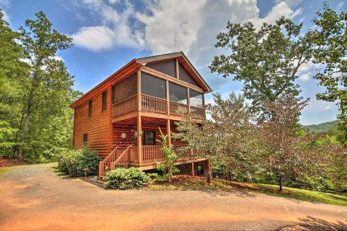 a cabin in the woods with a large window at Bearing Haus in Blue Ridge