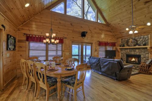 a dining room with a table and chairs and a fireplace at Bearing Haus in Blue Ridge