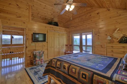 a bedroom with a bed and a flat screen tv at Bearing Haus in Blue Ridge