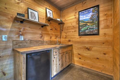 a television in a room with wooden walls at Cedar Ridge - Secluded Mineral Bluff Cabin - Hot Tub, Game Room, Outdoor Fireplace, Stunning Views in Mineral Bluff