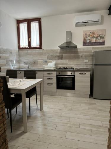 a kitchen with a table and a stove top oven at Il palazzo dell'alto prelato in Fondi