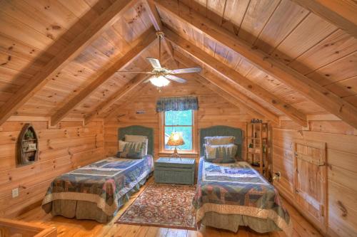 a bedroom with two beds in a log cabin at Falling Leaf - Mountain Views, Hot Tub, Game Room, Pet Friendly - Blue Ridge, GA in Blue Ridge
