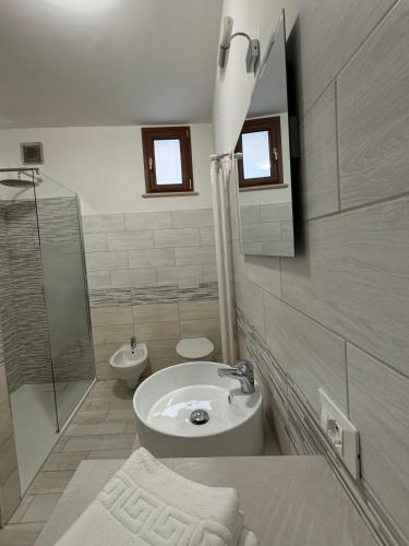 a bathroom with a sink and a shower and a toilet at Il palazzo dell'alto prelato in Fondi