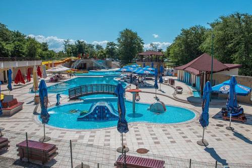 a large swimming pool with a water park at Apartman Sara S in Veliko Gradište