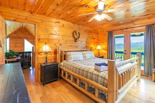 a bedroom with a bed in a log cabin at Hawks Hideaway in Mineral Bluff
