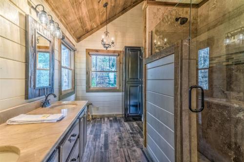 a bathroom with a sink and a shower and a tub at Mountain Melody in Morganton