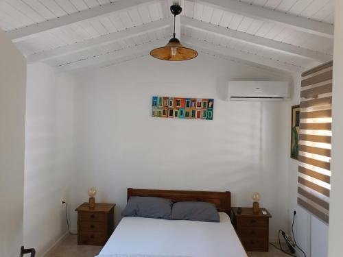 a bedroom with a bed and a shelf on the wall at Vasilis Studios in Animborió