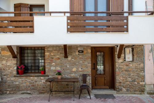a house with a wooden door and a table and chairs at Martinis House in Pefkochori