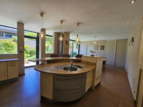 a large kitchen with a sink and a counter at Villa Bajocasse, maison Bayeux Centre Historique - 4 chambres in Bayeux
