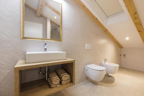 a bathroom with a sink and a toilet at Apartments Laura in Mali Lošinj