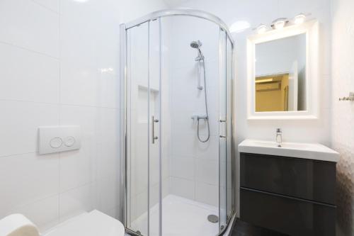 a bathroom with a shower and a toilet and a sink at Apartments Laura in Mali Lošinj