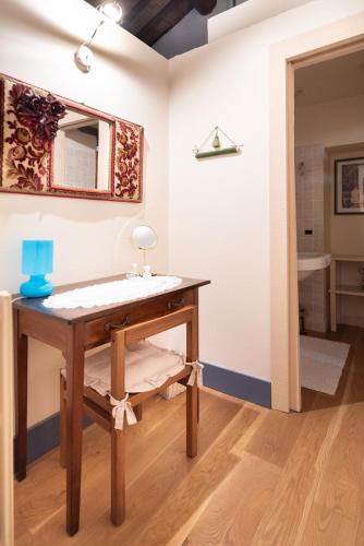 a bathroom with a wooden table and a mirror at La Vittoria 10 – La Soglia della Val d’Orcia in Chianciano Terme