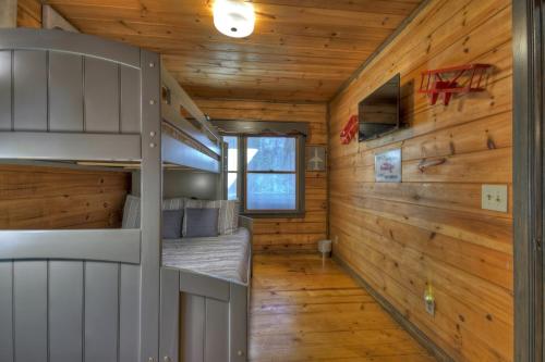 a bedroom in a log cabin with bunk beds at Traveller - Cabin with Hot Tub and Mountain Views - Hot Tub, Mountain Views, Ping Pong Table, Modern Amenities - Cherry Log, GA in Cherry Log