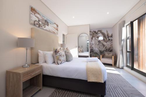 a bedroom with a large bed and a mirror at Moyana 14 in Ballito