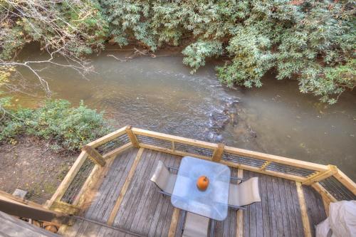an overhead view of a deck with two chairs and a river at Happy Trout Hideaway - Creek Views Of Hot House Creek, Hot Tub, Outdoor Fire Pit, Cozy Atmosphere - Mineral Bluff, GA in Mineral Bluff