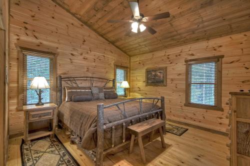 a bedroom with a bed in a log cabin at Altitude Adjustment - Blue Ridge - Mountain Views in Blue Ridge