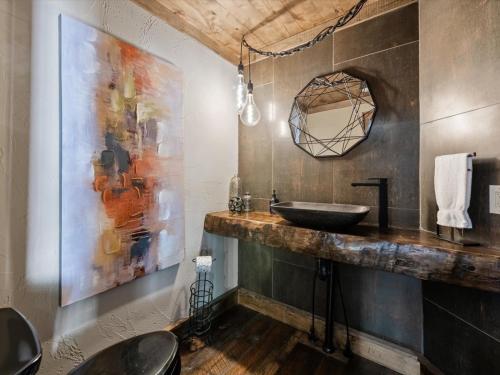 a bathroom with a sink and a mirror at River Joy Lodge - Luxury Home on the Ellijay River in Cherry Log