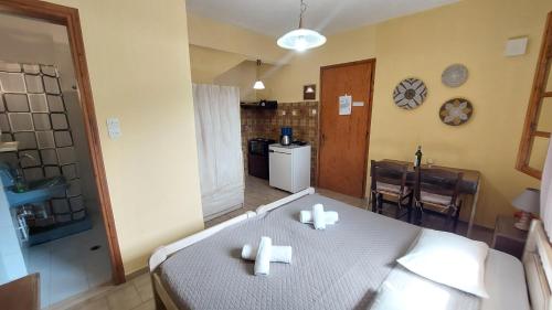 a room with a bed with two candles on it at VASILAKI Apartments in Vathi, Ithaka