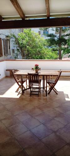 a wooden table and chairs on a patio at Casa Cecilia in Favignana