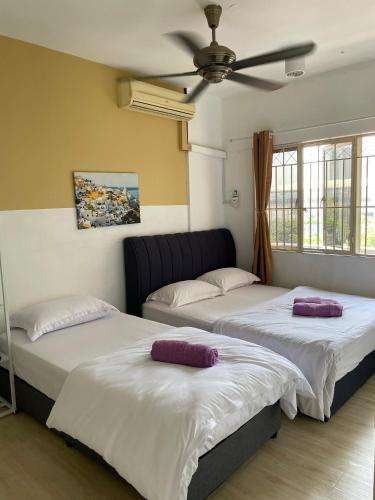 two beds sitting next to each other in a room at Apartment Next to Unifi Arena Axiata, Stadium Bukit Jalil in Kuala Lumpur